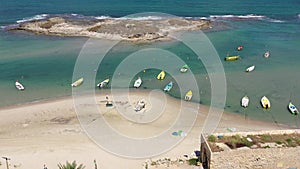 Small Fishing Boat anchored in a shallow lagoon, Aerial view.