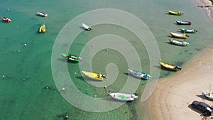 Small Fishing Boat anchored in a shallow lagoon, Aerial view.