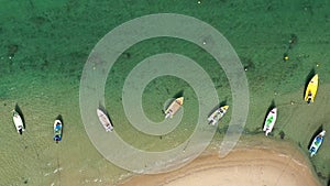 Small Fishing Boat anchored in a shallow lagoon, Aerial view.
