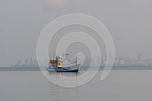 A small fishing boat is anchored. Stop back from Fishing near the coast