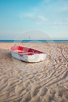 Small fishing boat on the beach and blue sky