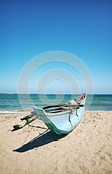 Small fishing boat on a beach, color toning applied, Sri Lanka