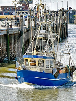 A small fishing boat enters the harbour of BÃ¼sum in North Frisia in Germany.