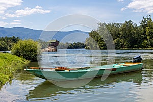 Small fishing boat in front of the famous wooden house on the Drina river in Bajina Basta, Serbia photo