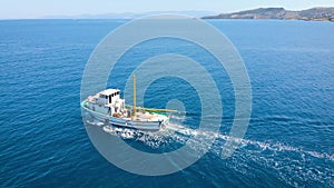 A small fishing boat goes to the open sea to search for and catch salmon.