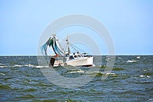 Small fishing boat heading out to the ocean