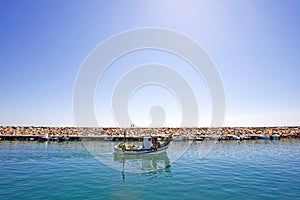 Small fishing boat leaving the port of Duquesa in Spain