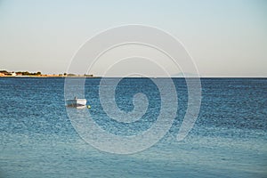 Small fishing boat moored on a sea