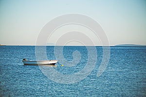 Small fishing boat moored on a sea