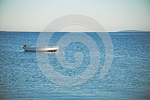 Small fishing boat moored on a sea