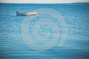 Small fishing boat moored on a sea