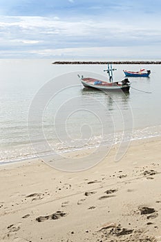 Small fishing boat mooring at the beach