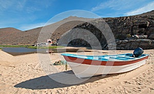 Small fishing boat / ponga at Punta Lobos beach on the coast of Baja California Mexico