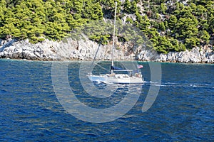 Small fishing boat sailing in the sea at Skiathos Island in Greece