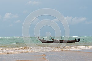 Small fishing boat in a storm near beach