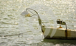 Small fishing boat on sunset