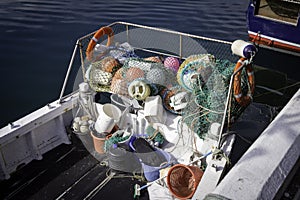 A small fishing boat with a variety of floats