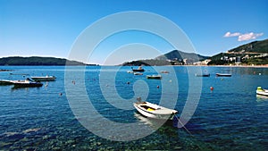 Small fishing boats on the azure water in the center of Budva, in Montenegro