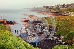 Small fishing boats on a foggy morning in Berneray, North Uist,