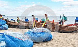 small fishing boats and nets on sand beach. Thailand Old fishing boat. colored boats with nets and gear for fishing