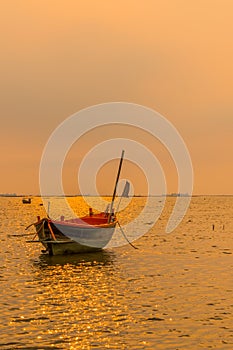 Small fishing boats on the sea during sunset and clouds