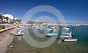 Small fishing boats and yachts moored in Roquets del Mar port or