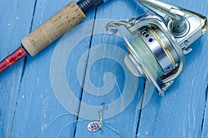 Small fishing spoon, fishing reel, spinning for pike, bass, predator fishing.