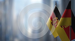 Small flags of the GDR on an abstract blurry background