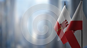 Small flags of the Gibraltar on an abstract blurry background