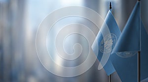 Small flags of the International Intellectual Property Organization on an abstract blurry background