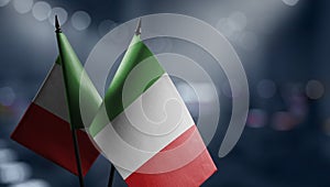 Small flags of the Italy on an abstract blurry background