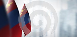 Small flags of Mongolia on a blurry background of the city photo