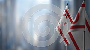 Small flags of the Northern Cyprus on an abstract blurry background