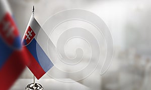 Small flags of the Slovakia on an abstract blurry background