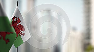 Small flags of the Wales on an abstract blurry background