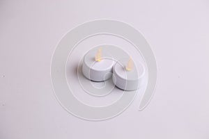 Small flameless candles on a white background