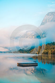 Small floating pier on lake Bohinj surface in summer morning