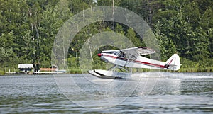 Small floatplane lands on a Minnesota lake