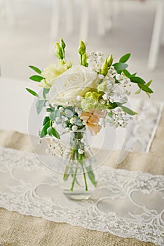 A small flower bouquet on a wedding ceremony table