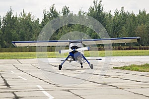 Small flying sport airplane stay on runway