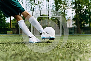 a small football player kicks the ball at the goal. The boy hits the ball. Boy Playing Soccer Game