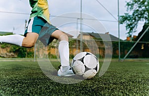 a small football player kicks the ball at the goal. The boy hits the ball. Boy Playing Soccer Game