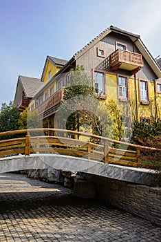 Small footbridge before exotic houses at sunny winter noon