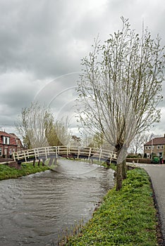 Small footbridge over a narrow Dutch river