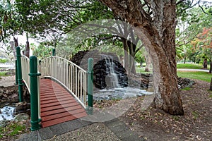 Small footbridge and waterfall in Macintosh island park.