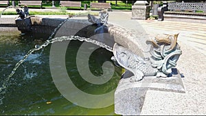 Small fountain in city park. refreshing coolness on bright summer hot day