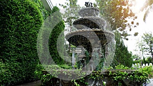 Small fountain in the middle of the green park.