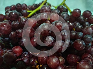 Small fresh grapes are typically characterized by their petite size and vibrant red color.