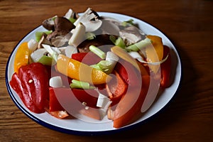 Small fresh red and yellow peppers with mushrooms and spring onions