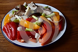 Small fresh red and yellow peppers with mushrooms and spring onions